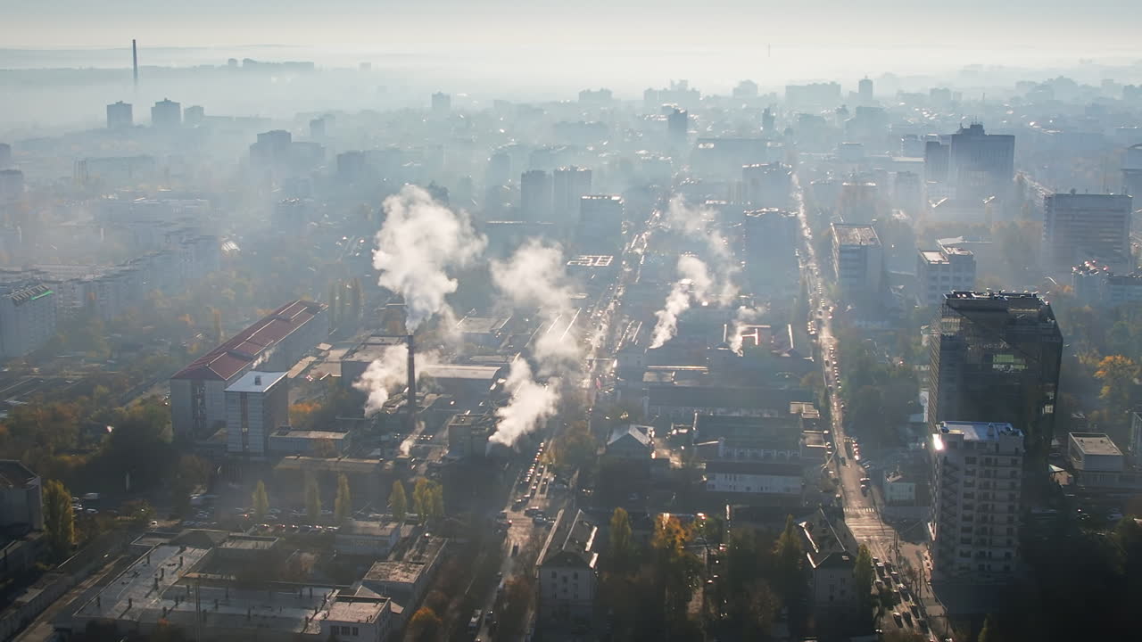 Aerial drone view of Chisinau at sunrise, Moldova. View of the city with fog in the air, multiple buildings, streets with cars