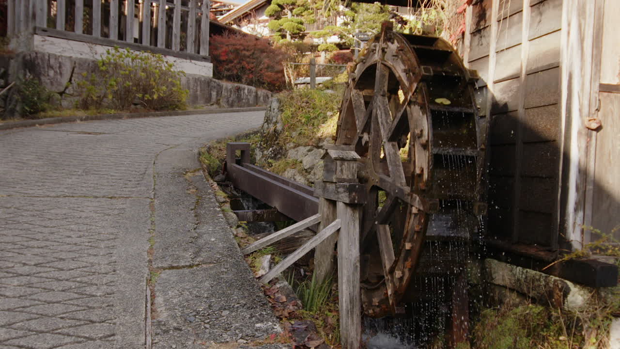 Famous old waterwheel in Tsumago Nakasendo town spins in slow motion