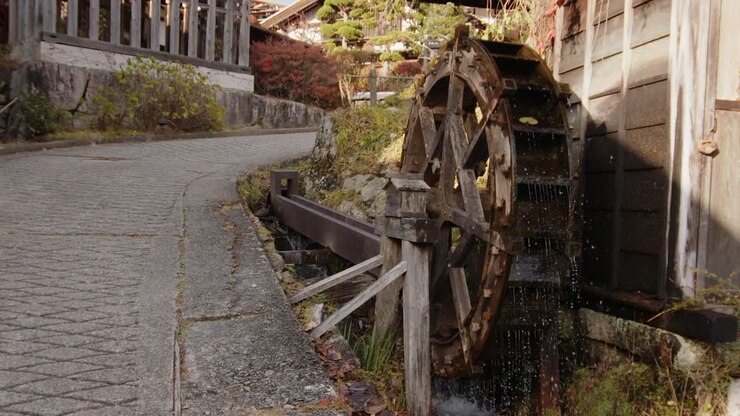 Famous old waterwheel in Tsumago Nakasendo town spins in slow motion
