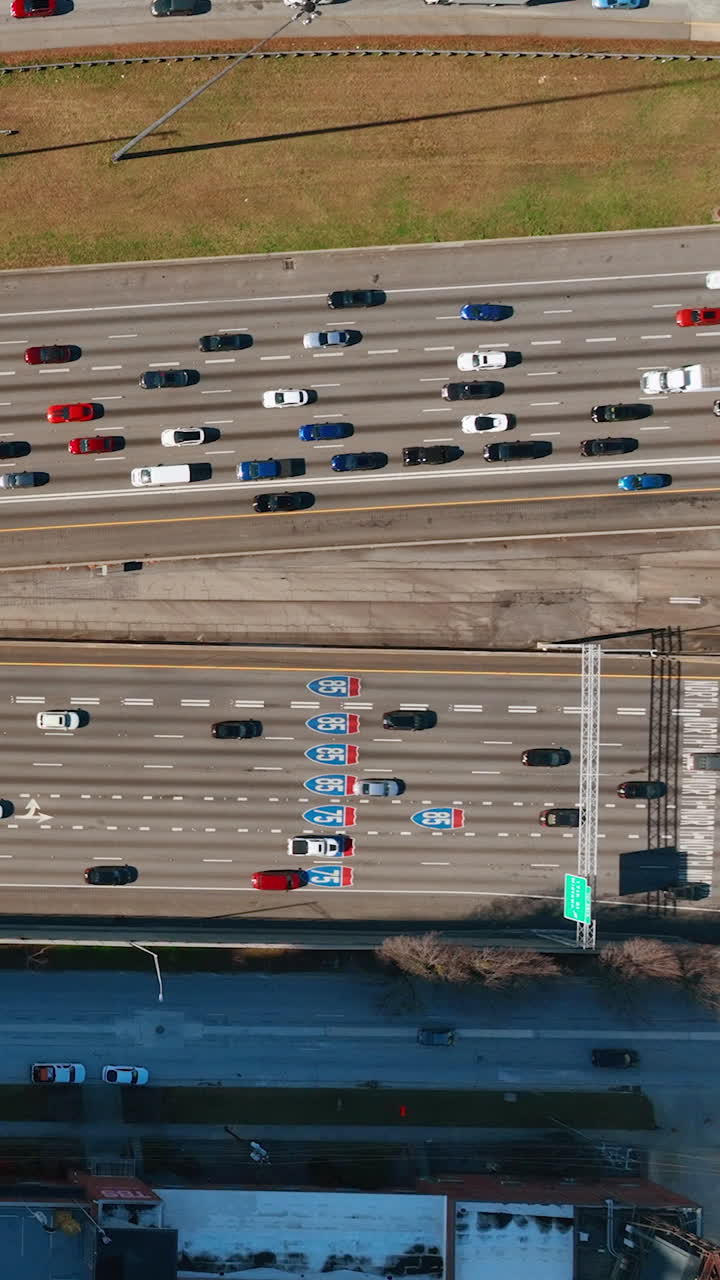 Car traffic on multi-lane freeway in Atlanta. Interstate I-85, Georgia. Aerial overhead. Traffic jam with cars on road. Vertical video