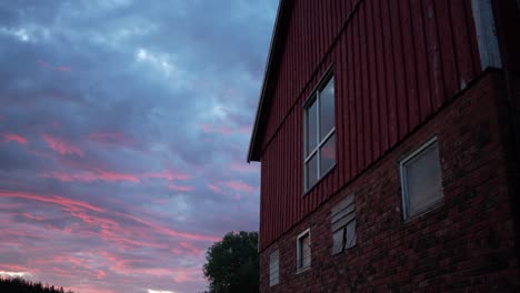 rustic barn house against red sunset sky