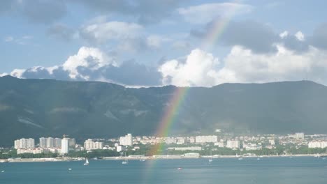 rainbow over a coastal city