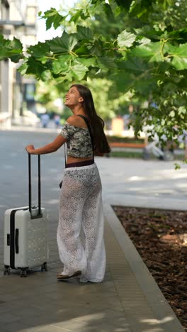 woman with suitcase walking outdoors