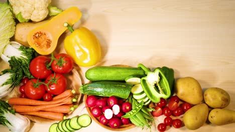 hands arranging colorful vegetables on a table