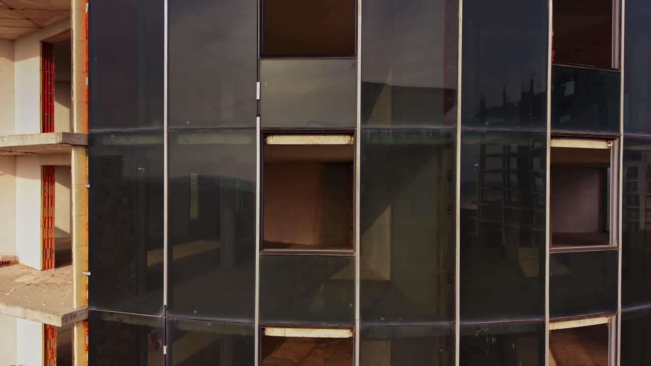 Construction site with modern glass facade during daylight hours