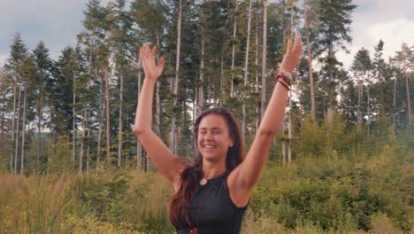 happy caucasian girl thanking the heavens and dancing into nature joyfully