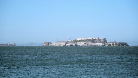 área de la bahía de san francisco, isla de alcatraz y buque de carga que pasa