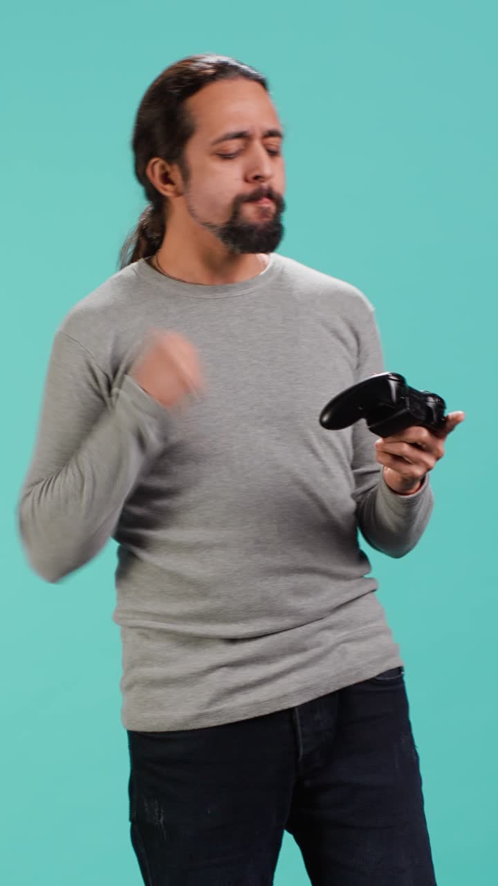 Vertical video Cheerful player happy after winning gaming console game, shaking fist,
