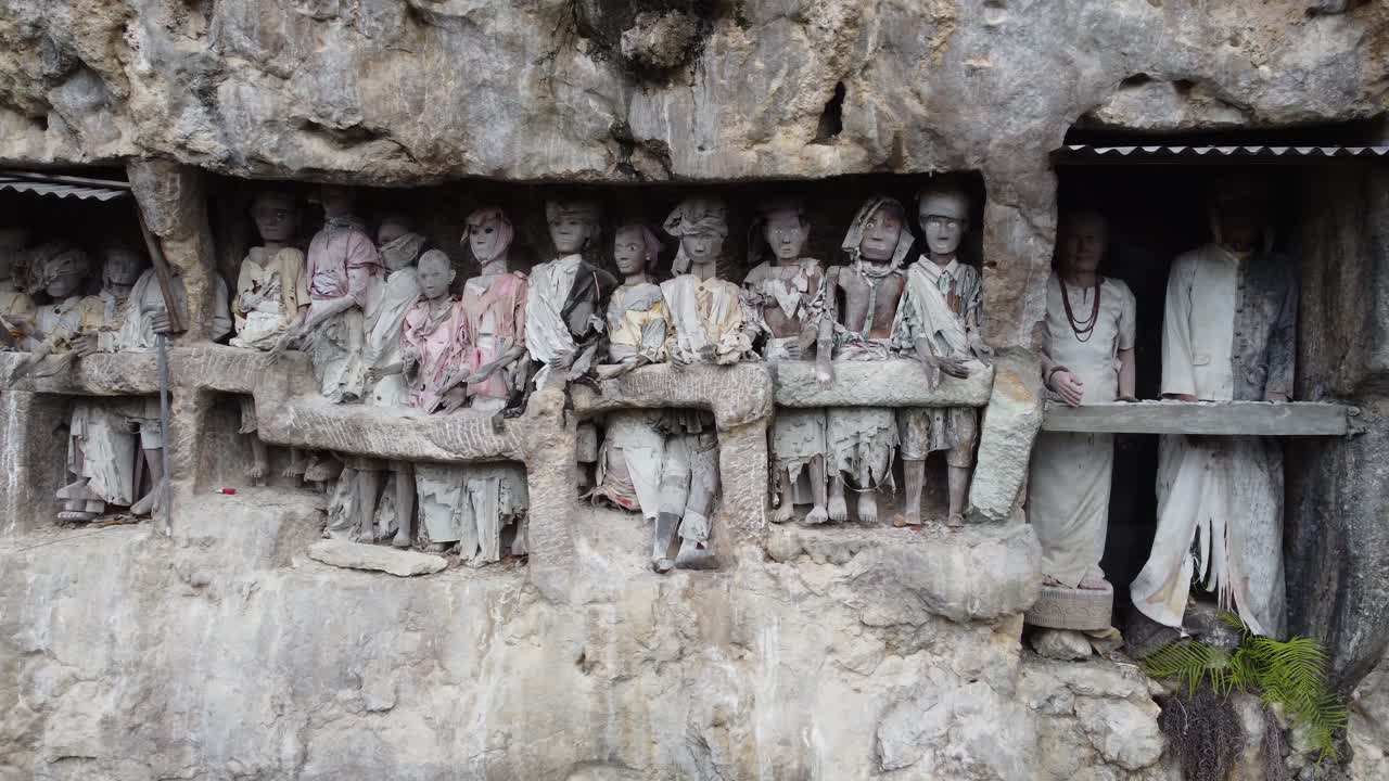 Ancient Torajan Tau Tau Effigies in Cliff Burial Sites