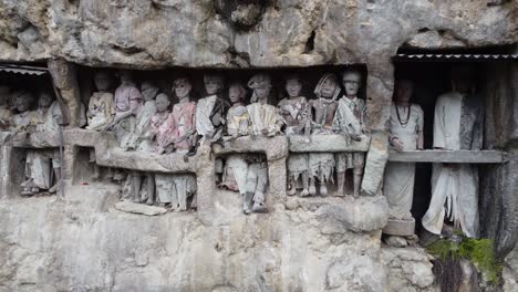 ancient torajan tau tau effigies in cliff burial sites