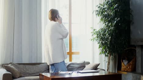 woman talking on phone in living room