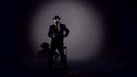 mysterious man in suit and fedora smoking pipe under spotlight