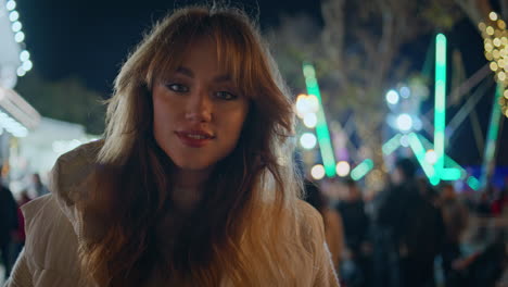 relaxed woman walking festive market under night bright lights closeup smiling