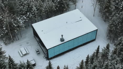 Mirrored-Exterior-Of-Reflexion-Cabin-In-The-Middle-Of-Winterly-Forest-At-Charlevoix,-Quebec-Canada