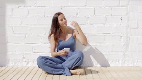 happy young woman listening to music in the sun