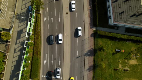 aerial - following moving forward cars on highway road near gdynia witomino forest, poland