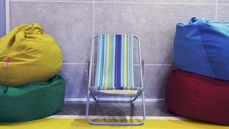 colorful lounge area with beach chair and bean bag chairs