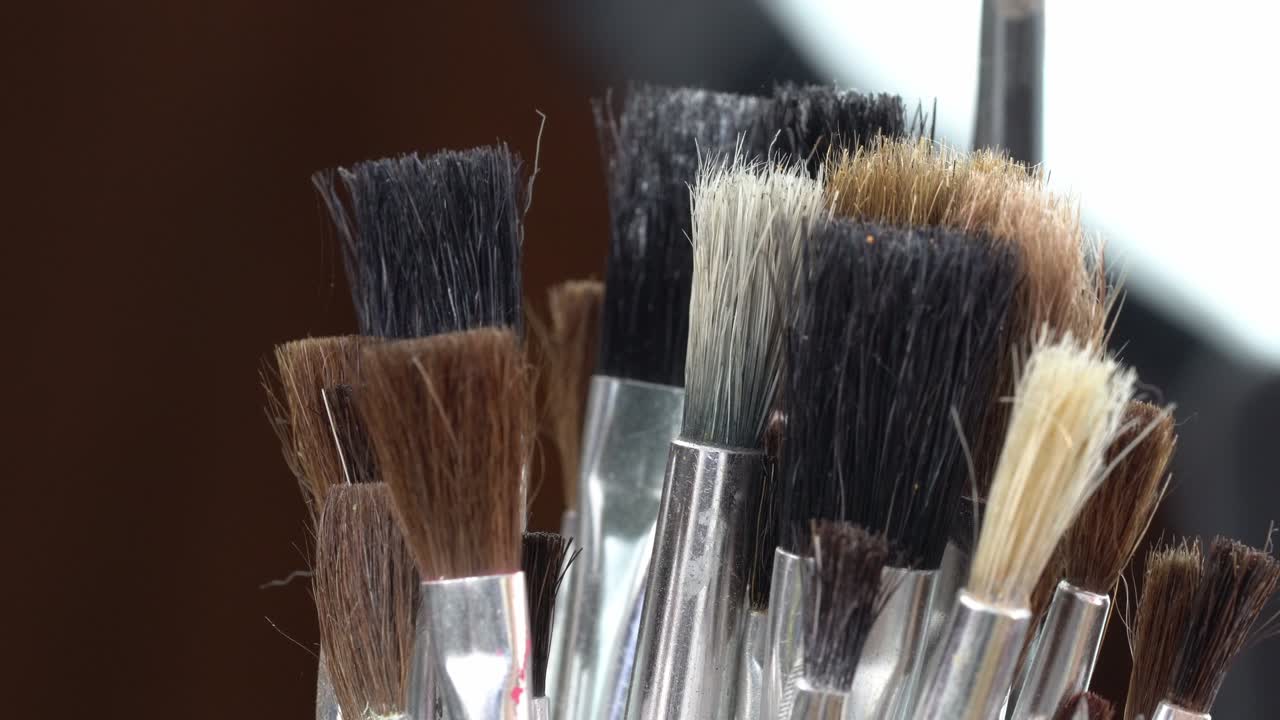 Assorted makeup brushes in a holder, showcasing beauty tools