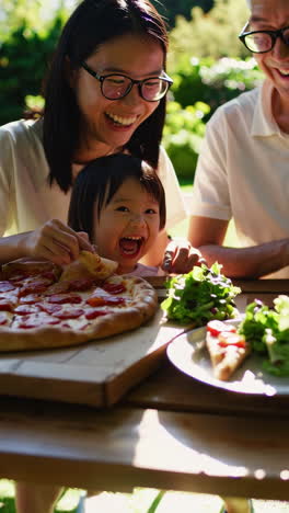 happy family enjoying an outdoor pizza meal