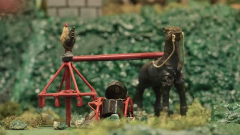 automated nativity scene featuring a horse turning a mill mechanism with a rooster perched on top