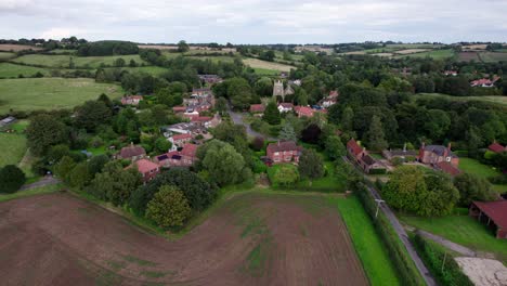 Aerial-video-footage-of-the-remains-of-Bolingbroke-Castle-a-13th-century-hexagonal-castle,-birthplace-of-the-future-King-Henry-IV,-with-adjacent-earthwork