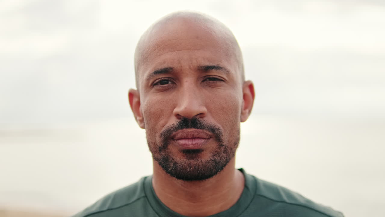 Close-up of Bald Man with Beard Opening Eyes and Looking at Camera