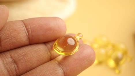 Close-up of a skincare serum capsule in hand