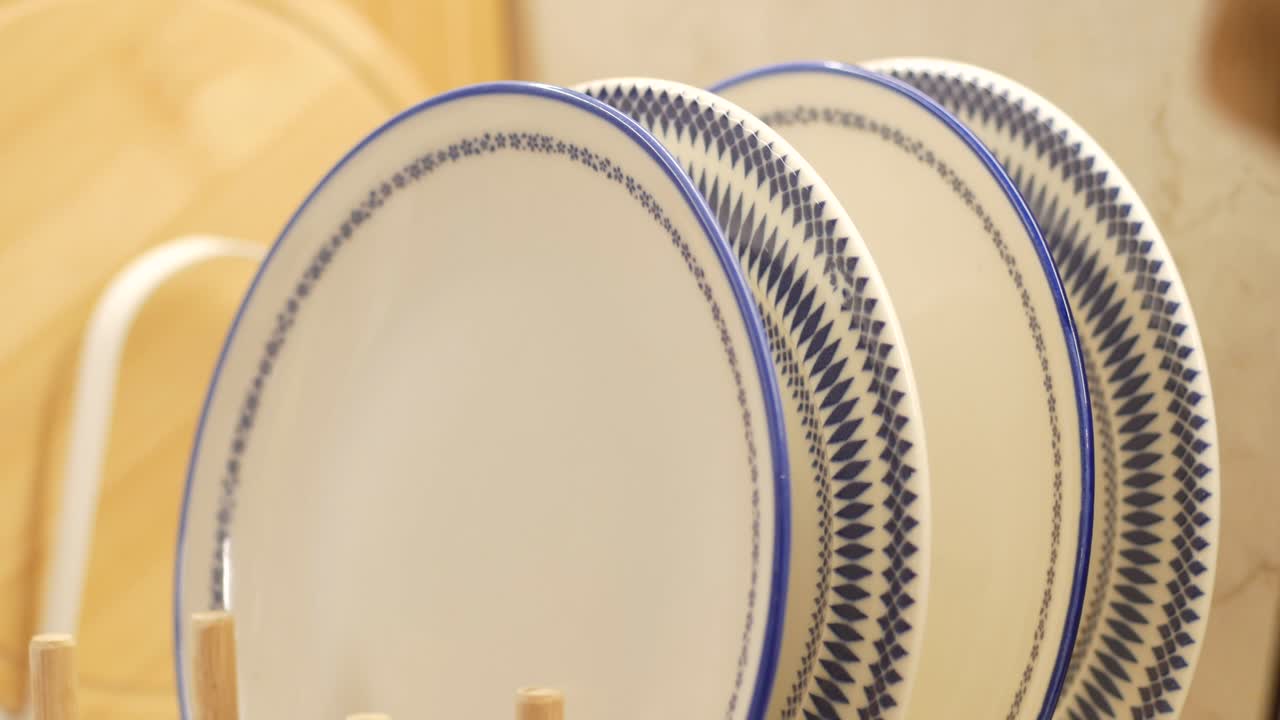Stacked Patterned Plates on a Wooden Rack