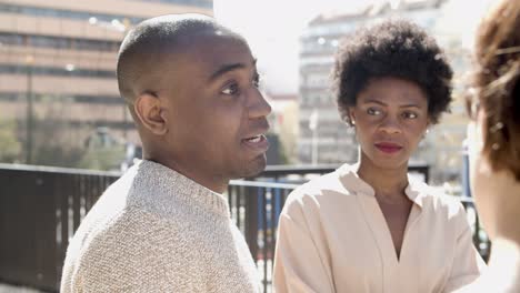 Confident-African-American-man-talking-to-friend-on-street