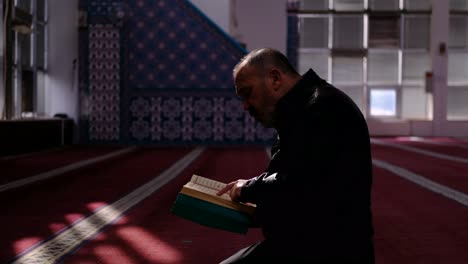 middle age man reads quran in mosque 3