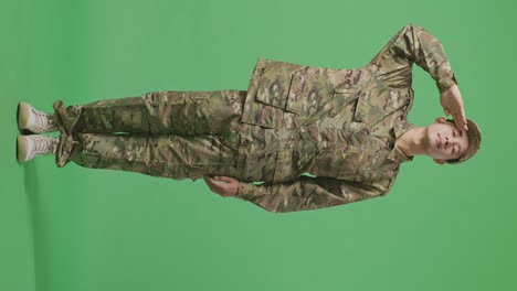 full body of asian man soldier saluting while standing in the green screen background studio