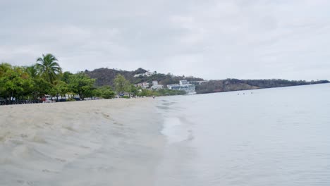 Tropical-sandy-beach-with-waves,-static-shot