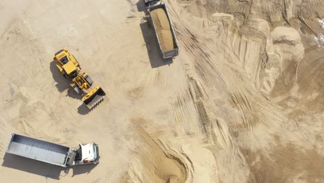 Aerial-view-loading-bulldozer-in-open-air-quarry