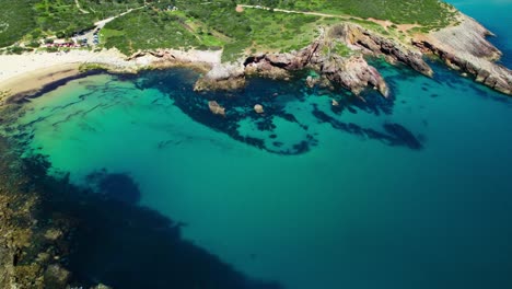 aerial view of beach, tranquil blue sea and rugged coastline in summer