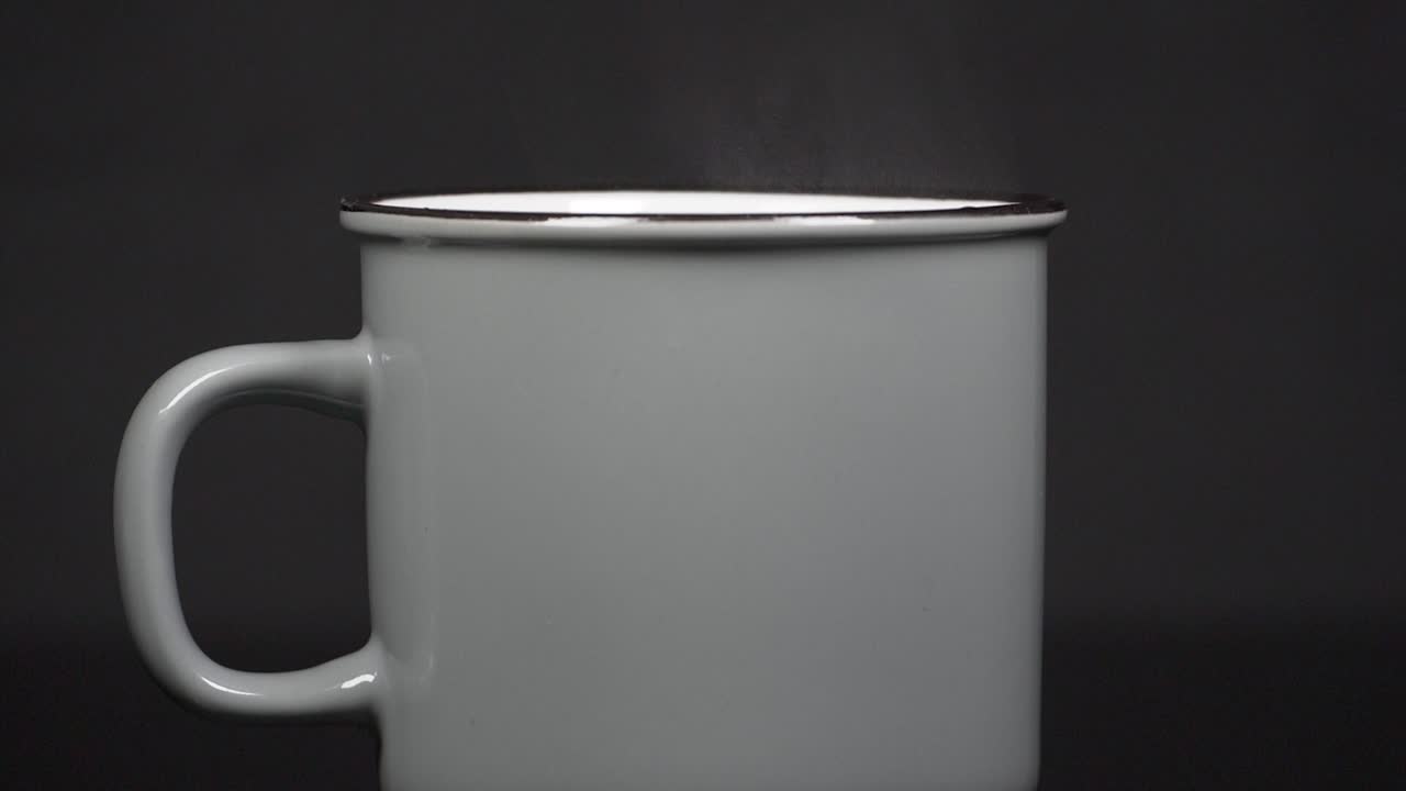 Filling cup with hot water with vapour, slow motion 4K