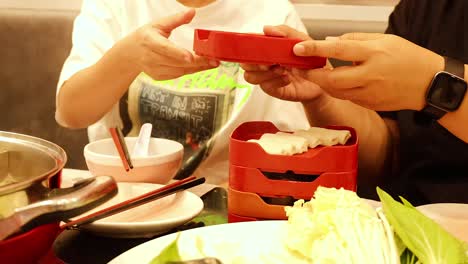 friends enjoying hotpot together in bangkok restaurant