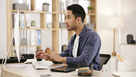 man working at a computer in a modern office