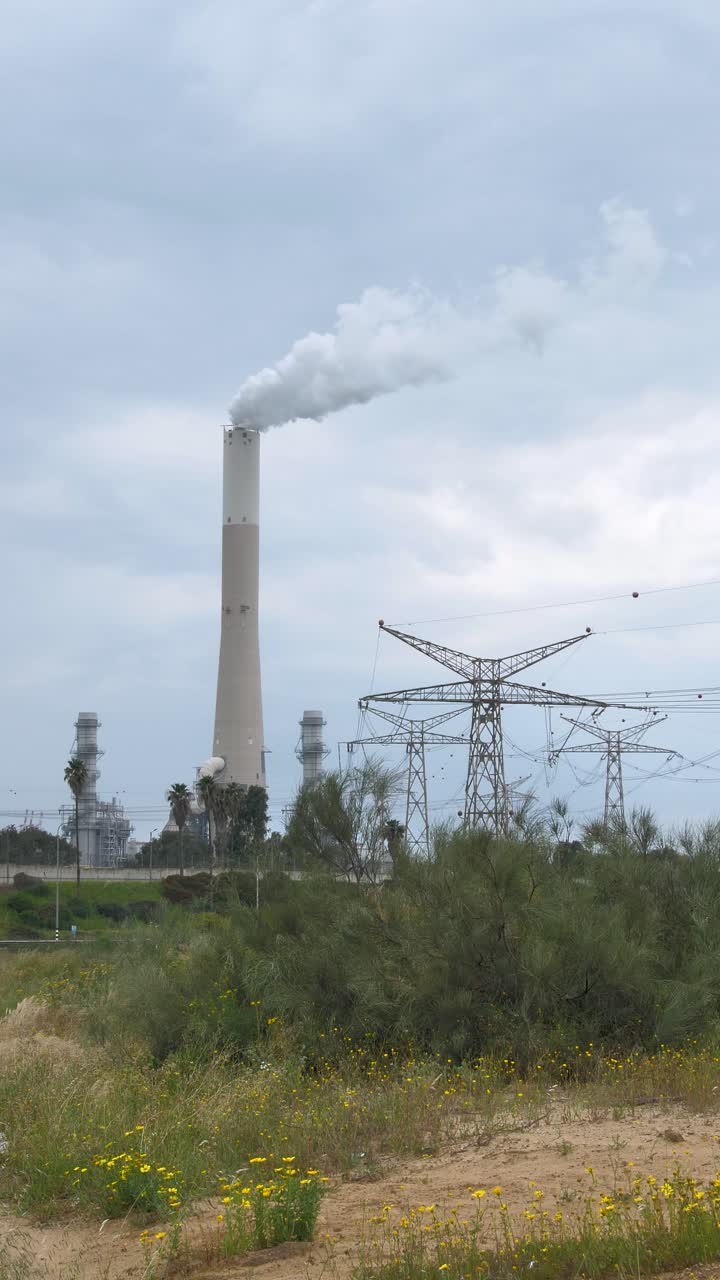 Komín elektrárny na fosilní paliva, znečištění životního prostředí a emise.