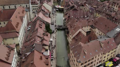 annecy river canal in old town, establishing aerial tilt-up reveal