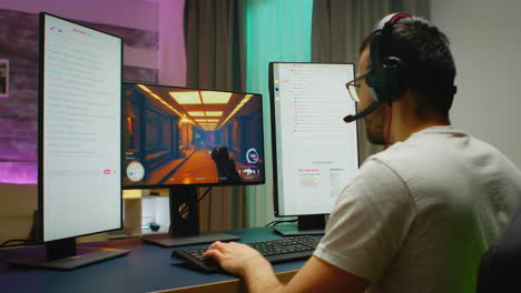 young man wearing headphones talking with other players