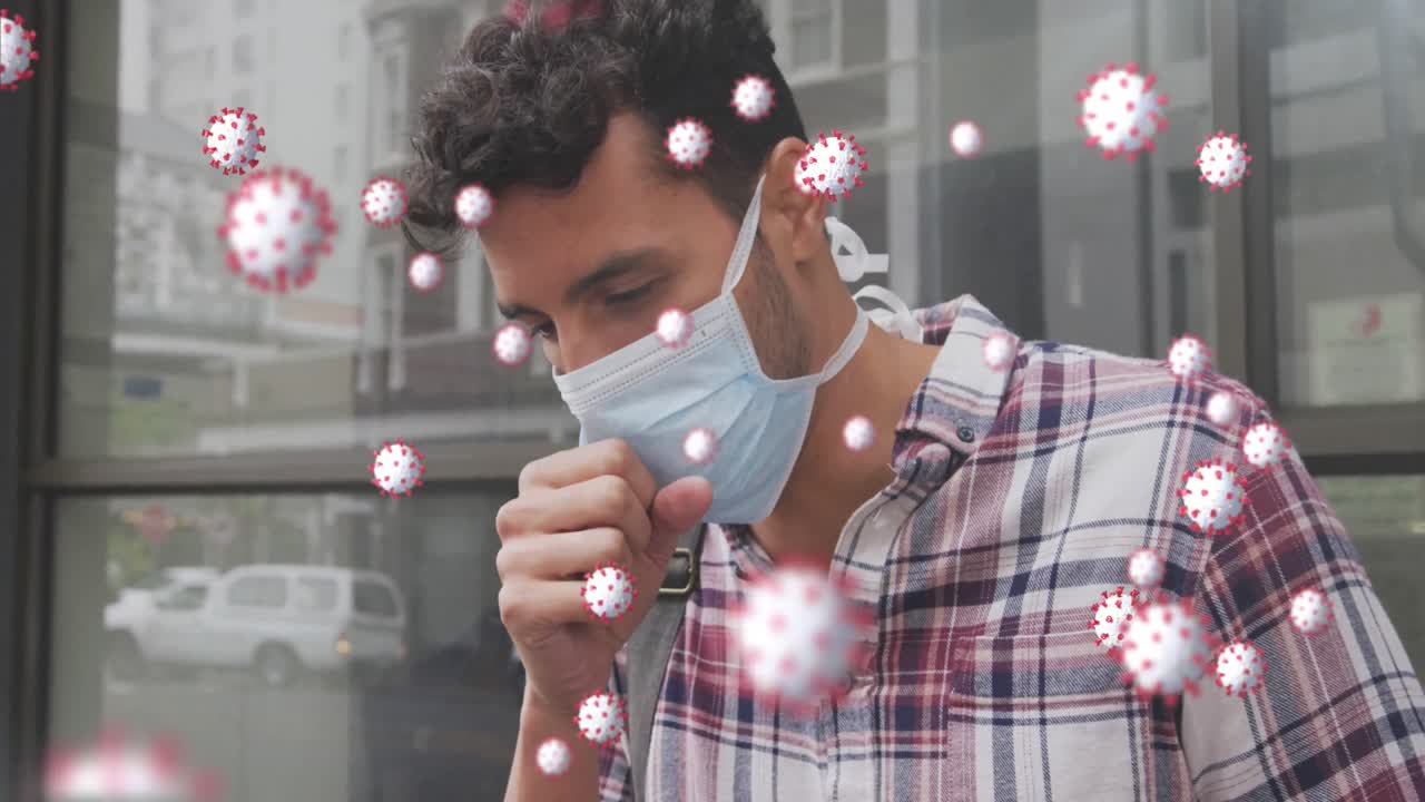 Animation of covid 19 cells over caucasian man wearing face mask coughing