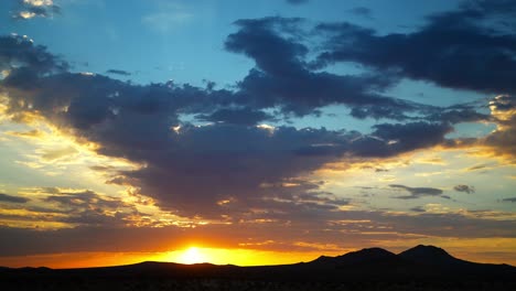 golden sunrise time lapse over the silhouetted mountains of the mojave desert