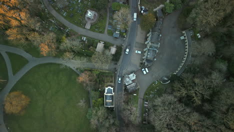 top down slow rotation view of highgate cemetery entrance west with traffic flow next to waterlow park london uk