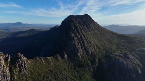 The rugged rocks of Tasmania's Cradle Mountain range stand out against a bright blue sky.