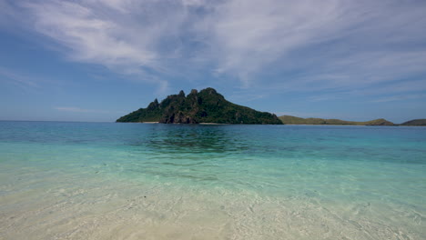 Islands-in-Fiji-with-clear-blue-water-on-a-sandy-shoreline