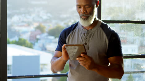 senior man using digital tablet at home 4k