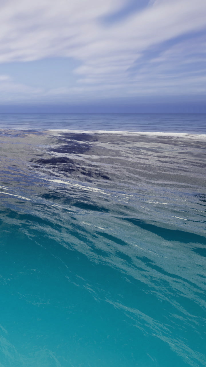 Calm waves dance under a vast blue sky at the tranquil ocean