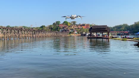 Static-view-of-a-small-white-drone-overlooking-the-rural-town-of-Sangkhlaburi-in-the-Kanchanaburi-province-of-Thailand,-aerial-content-creation