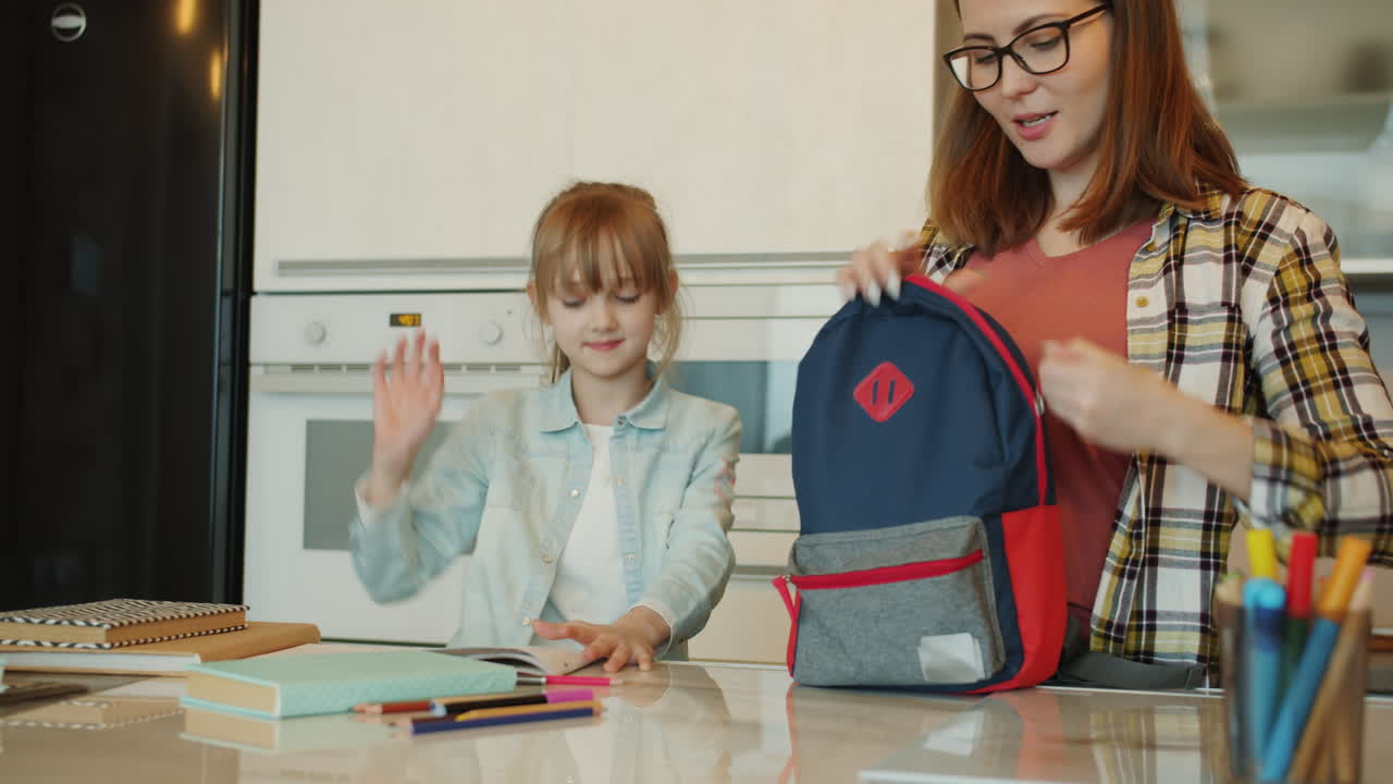 Mother and Daughter Getting Ready for School in the Kitchen