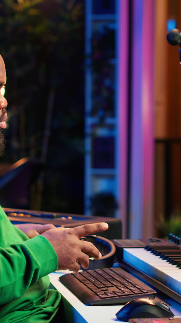 African American Man Playing Keyboard and Producing Music in Studio